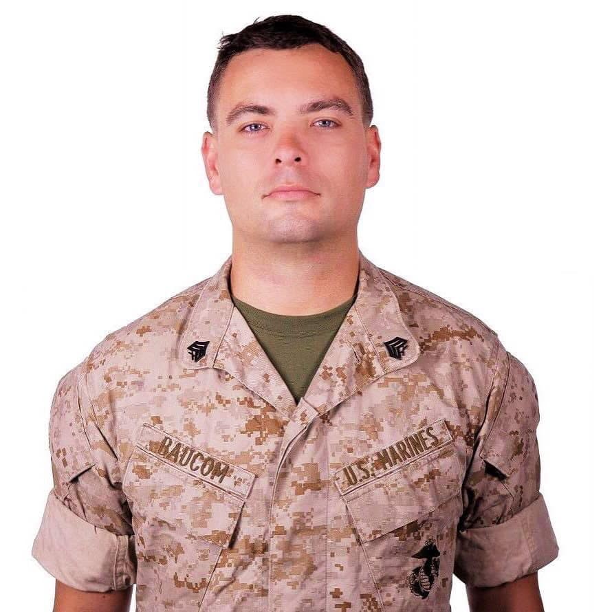 A man in military camouflage uniform posing for a portrait.